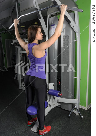 Beautiful fit woman exercising building muscles Beautiful fit woman exercising building muscles 29637862