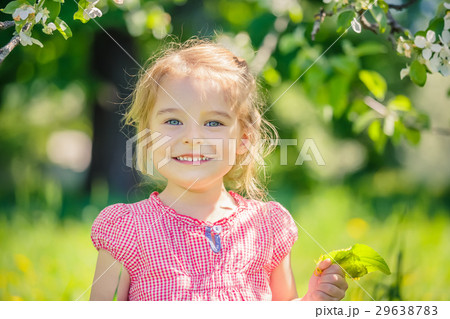Happy little girl in apple tree garden 29638783