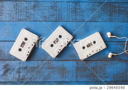 Audio tape with earphones on blue wooden table Audio tape with earphones on blue wooden table 29640590
