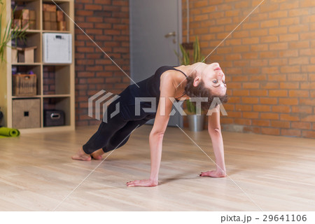 Woman doing yoga exercise standing in Table Top Woman doing yoga exercise standing in Table Top 29641106