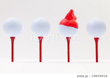 White golf balls with funny cap.  29649916