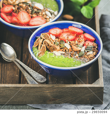 Green smoothie bowls with seeds, nuts and fruit Green smoothie bowls with seeds, nuts and fruit 29650094
