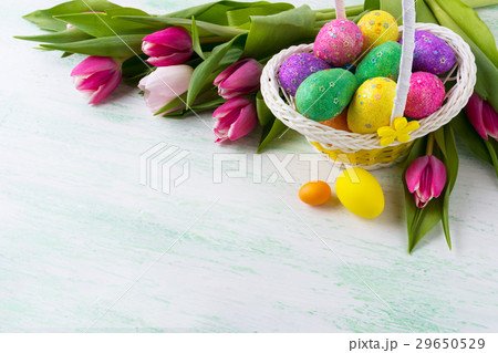 Easter multicolored glitter eggs in wicker basket Easter multicolored glitter eggs in wicker basket 29650529