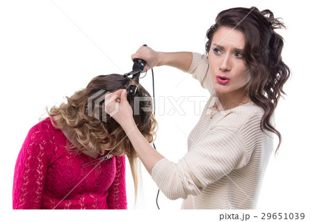 Blond client with curls and surprised hairdresser 29651039