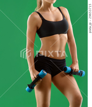 Young attractive woman with dumbbells in her hands Young attractive woman with dumbbells in her hands 29653715