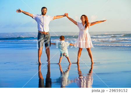 Happy family - father, mother, baby on beach Happy family - father, mother, baby on beach 29659152