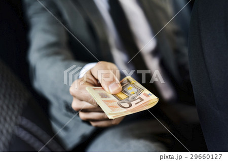 man with a wad of euro bills man with a wad of euro bills 29660127
