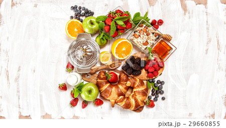 Breakfast with croissants muesli fresh berries Breakfast with croissants muesli fresh berries 29660855