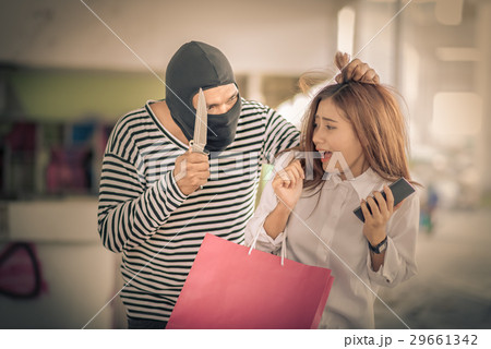 Thief stealing young woman shopping bag 29661342
