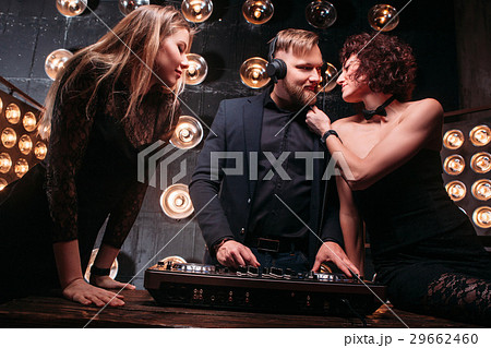 Two young girls flirt with DJ at nightclub party 29662460