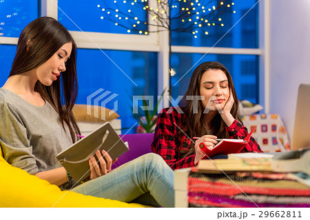 Thoughtful girls writing in notebook Thoughtful girls writing in notebook 29662811