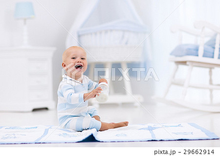 Baby boy drinking milk in sunny nursery Baby boy drinking milk in sunny nursery 29662914