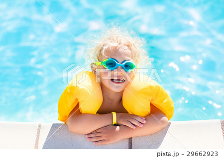Little baby boy playing in swimming pool Little baby boy playing in swimming pool 29662923