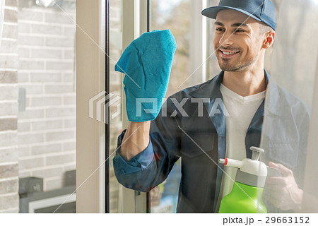 Cheerful male person cleaning window 29663152