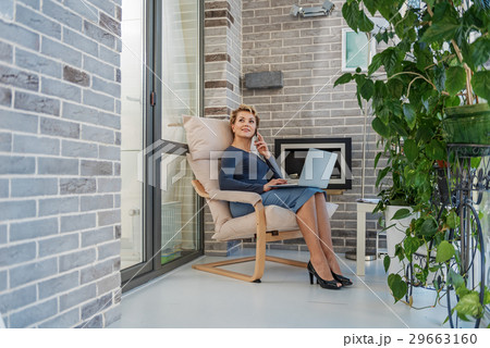 Thoughtful lady resting on balcony Thoughtful lady resting on balcony 29663160