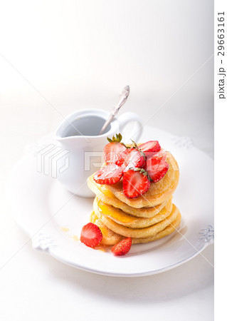 Stack of sweet pancakes with strawberry and honey. 29663161