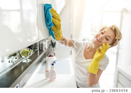 Gabby smiling woman wiping cupboard Gabby smiling woman wiping cupboard 29663458