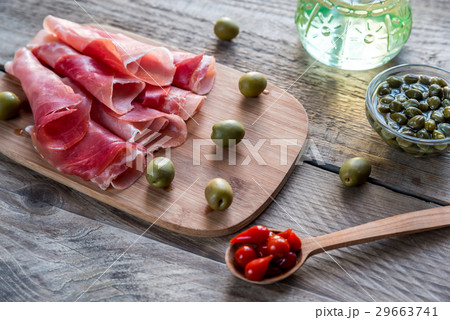 Jamon with capers and olives on the wooden board Jamon with capers and olives on the wooden board 29663741