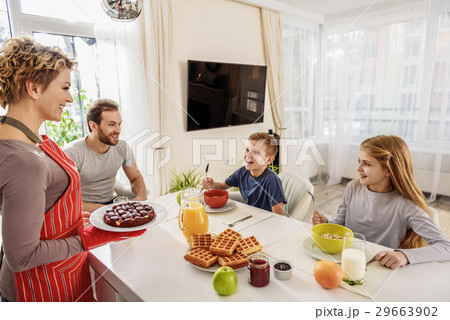 Happy family eating together at home Happy family eating together at home 29663902