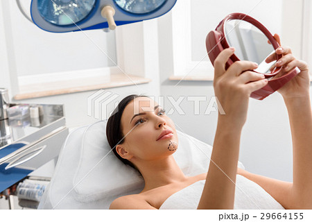Serene woman with correction marks in clinic 29664155
