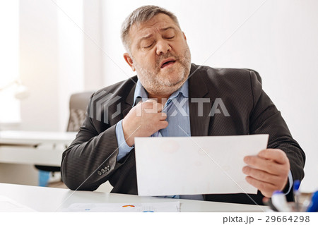 Overwhelmed hard-working man feeling stressed 29664298