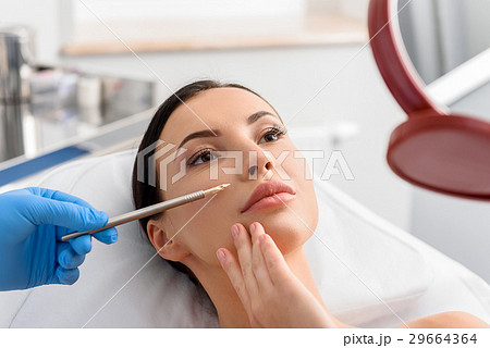 Calm girl watching at reflexion in surgery room 29664364