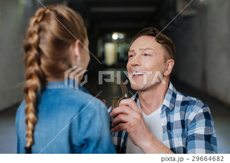 Joyful positive man helping his daughter 29664682
