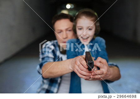 Cheerful positive girl having a shooting lesson 29664698