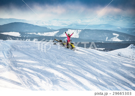 Rider on the snowmobile in the mountains Rider on the snowmobile in the mountains 29665303