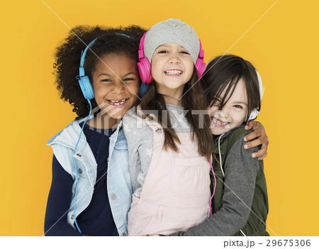 Group of Little Girls Studio Smiling Wearing Headphones and Winter Clothes 29675306