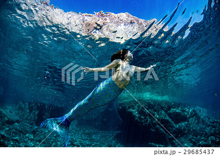 Mermaid swimming underwater in the deep blue sea Mermaid swimming underwater in the deep blue sea 29685437