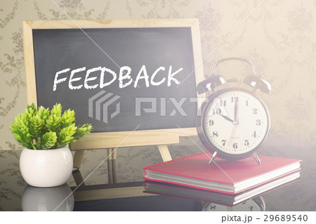 Feedback on blackboard with clock and flare Feedback on blackboard with clock and flare 29689540