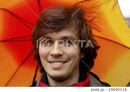 Man with Smile in the Rain with an Orange Umbrella Man with Smile in the Rain with an Orange Umbrella 29690318