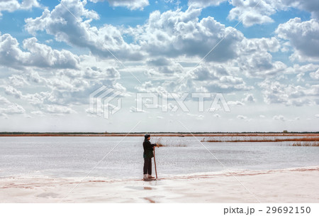 Man By The Lake Among Quartz Sand Under Cloudy Sky 29692150