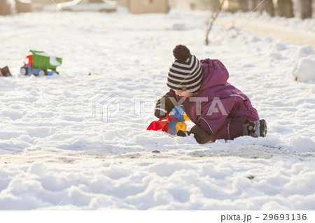Kid plays on the snow 29693136