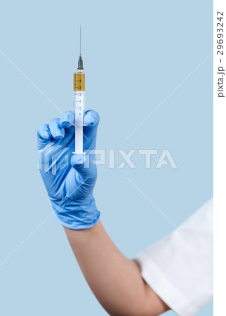 Hand with syringe close-up. 29693242