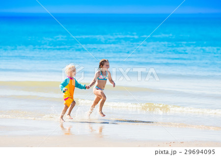 Kids run and play on tropical beach Kids run and play on tropical beach 29694095