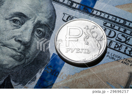 One ruble coin on dollar banknote One ruble coin on dollar banknote 29696257