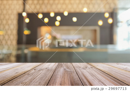 Empty wooden table top with blurred coffee shop. 29697713