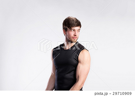 Handsome fitness man in black sleeveless shirt Handsome fitness man in black sleeveless shirt 29710909