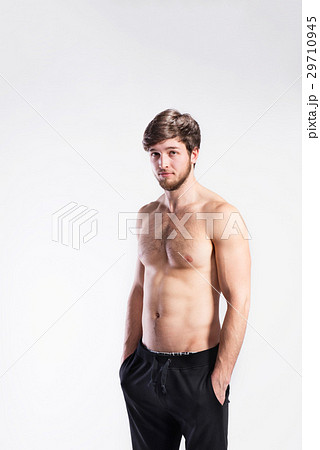 Shirtless fitness man, hands in pockets . Studio 29710945