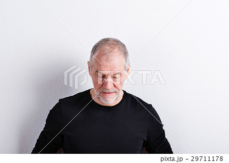 Senior man in black t-shirt, looking down, studio Senior man in black t-shirt, looking down, studio 29711178