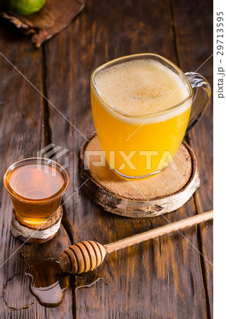An alcoholic mix with brandy, juice and honey 29713595