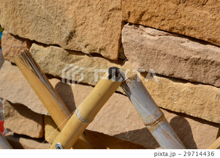 bamboo fence in front of brick wall 29714436