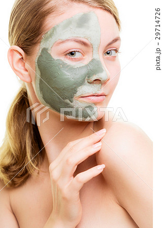 Woman in clay mud mask on face isolated on white. 29714726