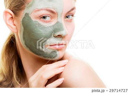 Woman in clay mud mask on face isolated on white. Woman in clay mud mask on face isolated on white. 29714727