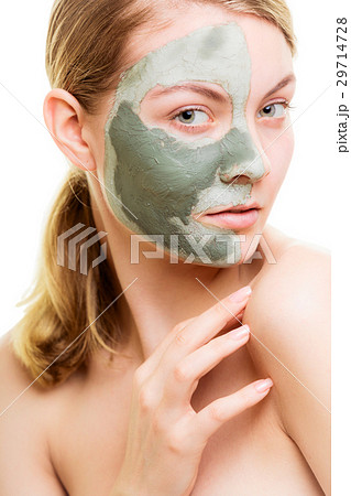 Woman in clay mud mask on face isolated on white. 29714728