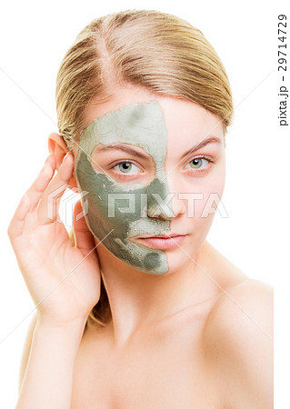 Woman in clay mud mask on face isolated on white. 29714729
