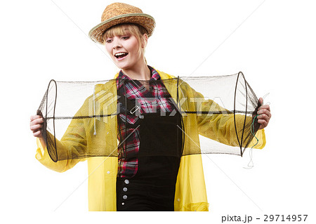 Happy woman holding empty fishing keepnet Happy woman holding empty fishing keepnet 29714957