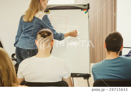 Teacher teaching mathematics to college students 29715633